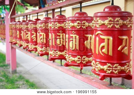 Detail of a Lamaism Datsan temple with red drums in a row