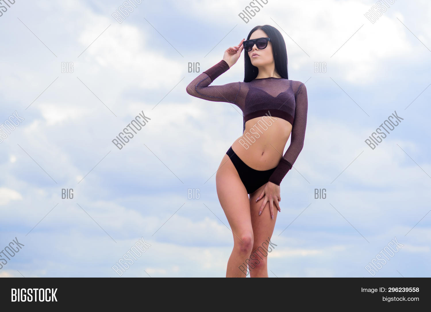 Free Photo  Shapely tanned woman in swimsuit playfully looking at