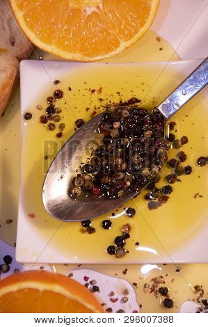 Olive Oil With Pepper In A Spoon