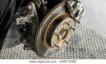 Car Parts And Disk Brake Concept - Closeup Car Disk Brake Maintenance Service In Car Garage And Copy