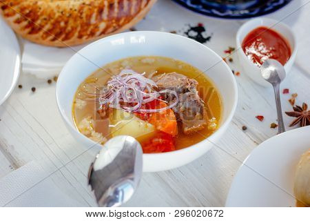 Uzbek Chorba - Soup From Fresh Meat And Vegetables On White Table, Great Image For Your Needs.