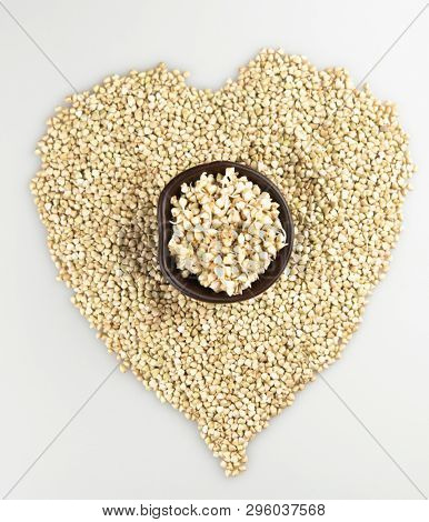 Sprouts of green buckwheat on white background. Macro shot raw organic buckwheat plant. Vegan germinated sprouts, vegetarian cuisine. Healthy diet buckwheat porridge food. 