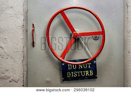 Do Not Disturb Warning Sign Plate Hanging On A Hermetic Bomb Shelter Armored Door