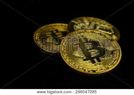 Golden Bitcoin Coins On A Black Background