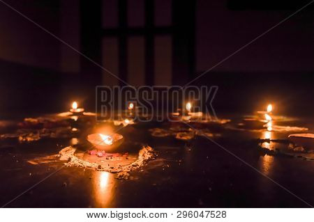 Happy Diwali. Diya Oil Lamps In Dipawali Celebration Decorated Over Handmade Rangoli.