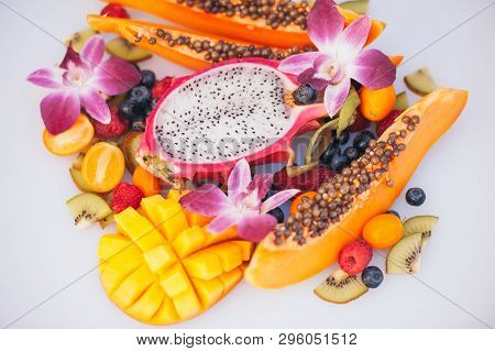 Fresh Organic Exotic Fruits On White Background. Ripe Dargon Fruit, Papaya, Kiwi, Mango With Kumquat