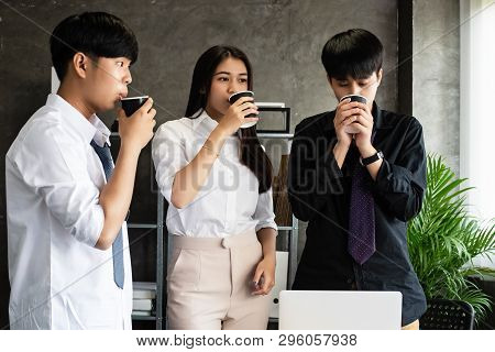 Young Business Partner Ddrinking Coffee Between Meeting,relax Time,at Office