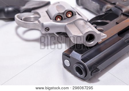 Two Handguns, A 40 Caliber Pistol And A 357 Magnum Revolver On A White Background