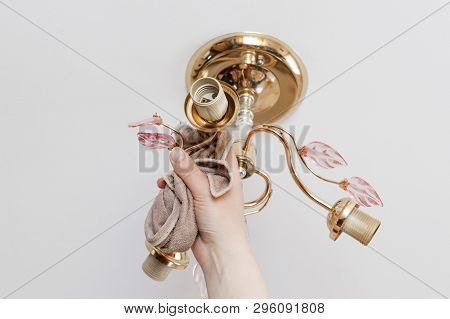 Lamp On The Ceiling Without Lamps. Girl Washes His Rag. Have Toning. Close-up