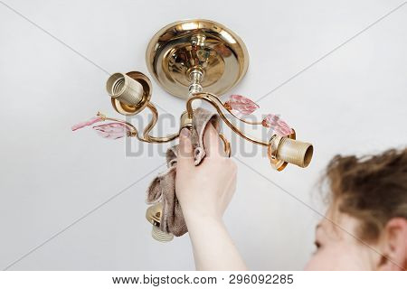 Lamp On The Ceiling Without Lamps. Girl Washes His Rag. Have Toning. Close-up