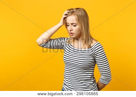 Portrait Of Preoccupied Young Woman In Striped Clothes Looking Down Aside Putting Hand On Head Isola