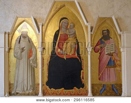 FLORENCE, ITALY - JANUARY 10, 2019: Madonna and Child with St. Gregory and St. Job, Triptych by Nardo di Cione, Basilica di Santa Croce (Basilica of the Holy Cross) in Florence, Italy