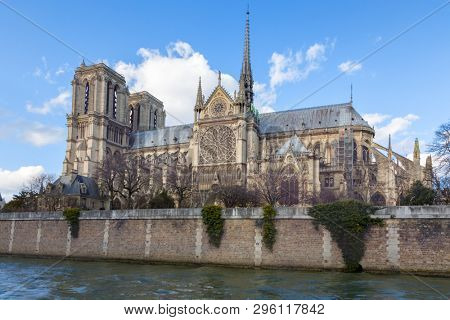 Notre Dame Cathedral in Paris. Springtime view. of the side elevation with spire and rear flying butresses, taken from across the river Seine. 