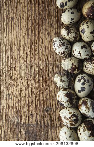 Quail Eggs. Flat Lay Composition With Small Quail Eggs On The Natural Wooden Background. One Broken