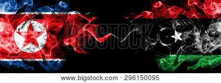 North Korea Vs Libya, Libyan Smoky Mystic Flags Placed Side By Side. Thick Colored Silky Smoke Flags