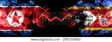 North Korea Vs Swaziland, Swazi Smoky Mystic Flags Placed Side By Side. Thick Colored Silky Smoke Fl