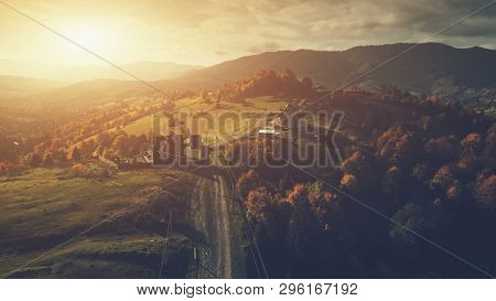 Panoramic Mountain Orange Sunset Countryside Scene. Aerial View. High Mountain Range Highland Rural Landscape. Tourism Concept. Soft Light Unpolluted Environment