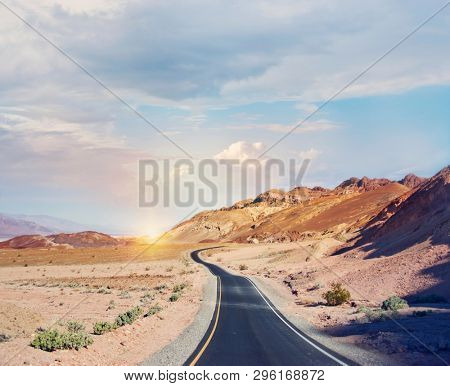 Desert road leading through Death Valley National Park, California USA.Artist's Palette scenic drive.