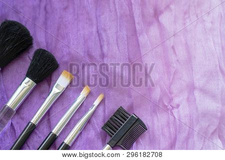 Professional Make-up Cosmetic Brushes On The Background Of Crumpled Wavy Fabric. The Concept Of Beau