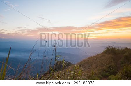 Gold Sunset Light With Mountain And Blue Sky And Grass Field At Twilight. Twilight Landscape Phu Nom