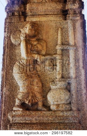 Sculpture Of Yashoda Making Curd At The Vittala Temple, Hampi, Karnataka, India