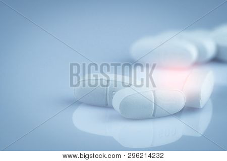 Pile Of White Oblong Tablets Pills On Gradient Background. Pharmaceutical Industry. Pharmacy Product