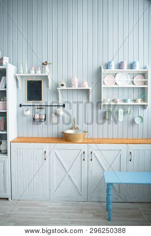 Bright Kitchen Set In Rustic Style With A Brown Wooden Worktop. On The Shelves Are White, Pink And B