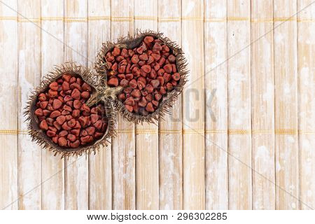 Annatto Seeds On Rustic Wood