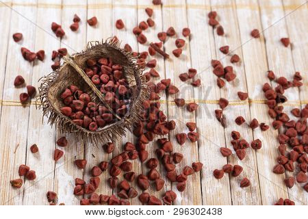 Annatto Seeds On Rustic Wood
