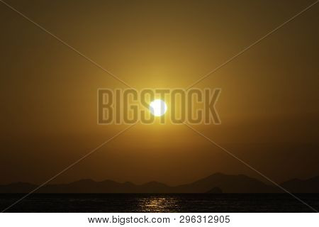 Golden Sunset Over The Sea, Mountain Lines At Background. Eighty Percent Of Copy Space In The Pictur
