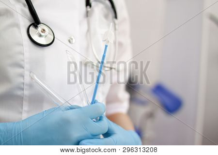 Gynecologist Doctor In White Uniform In Clinic Hospital With Medicine Instrument Vaginal Speculum, V