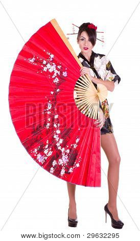 Beautiful young woman in Asian costume with red Asian fan