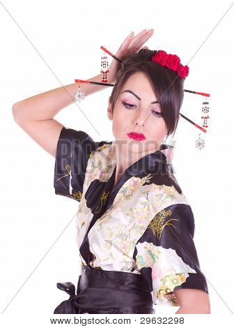 Beautiful young woman in Asian costume with red flowers