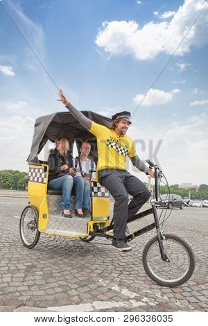 Paris, France - May 22, 2012: Man driving in bicycle taxi