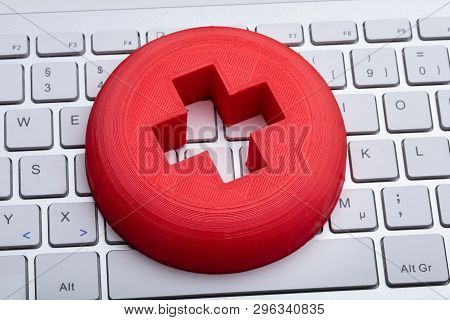Close-up Of First Aid Medical Sign On White Keyboard