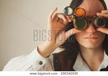 Steampunk Style Researcher Mechanist Of The Monocle With A Large Number Of Lenses Looking At Somethi