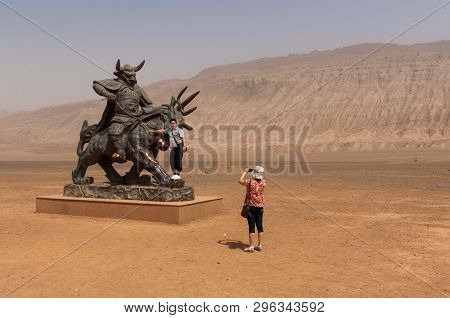 Flaming Mountains, Xinjiang, China - August 12, 2012: Chinese Tourists Taking Pictures In Front Of A