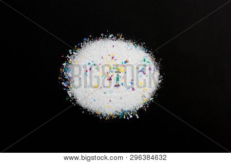 Microplastic Particles In Salt On Black Background. Water Pollution. Microplastic Problem. Threat To