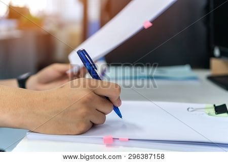 Document Report And Business Busy Concept: Businessman Manager Hands Holding Blue Pen For Reading An