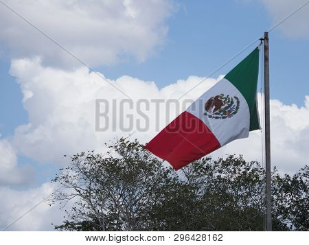 National Maxican Flag At Beauty Chichen Itza City Near Archaeological Site In Mexico With Trees And 