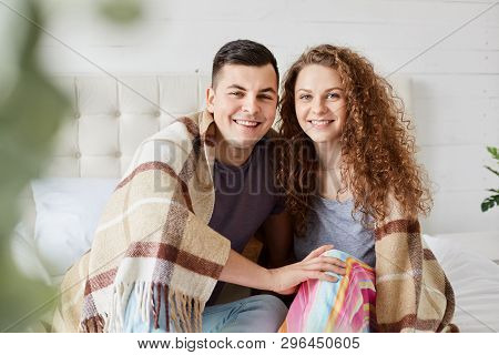 Close Up Portrait Of Romantic Couple In Love Sitting Under Warm Plaid In Bedroom, Embrace Each Other