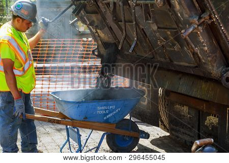 19 Apryl 2019 Ny. Usa Workers On A Industry Aying Fresh Asphalt Bitumen During Road Construction Cen