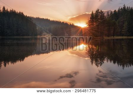 Beautiful Sunset View With Sun Rays Over A Mountain Lake. Shiroka Polyana Dam In Rhodopi Mountains, 