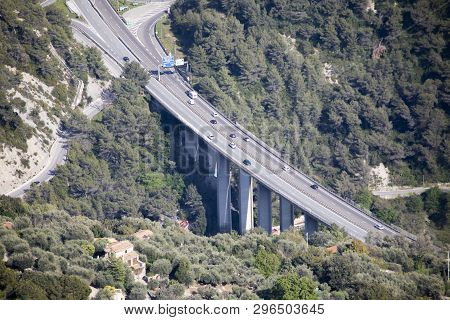 Menton, France - April 19, 2019: Aerial View Of Car Traffic On A Highway Bridge With Pillars And Fre