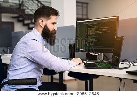 Software Programming. Bearded Man Working On Computer In It Office, Sitting At Desk Writing Code, Wo