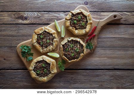 Beef Mince Sfiha - Arabian Opened Meat Pies On Brown Wood Background.