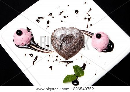 Dessert Fondan Chocolate With Ice-cream On A White Plate On A Black Background. Exquisite French Cho