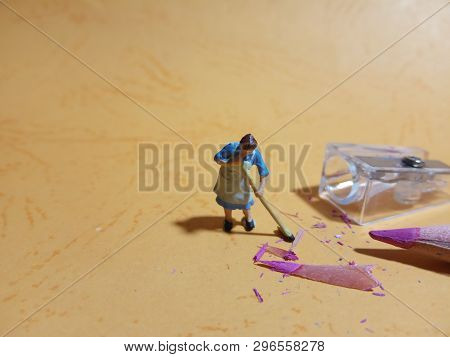 Photo 1 Woman Cleaning Trash From Pencil Sharpener With Negative Space