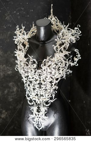 Piece made with 3d printer, is composed of white flowers that form a corset, handmade, fantasy design Baroque style