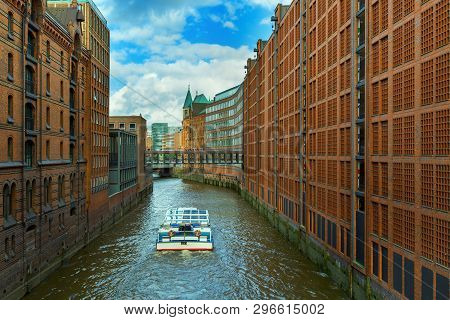 The Speicherstadt Is Popular Landmark Of City Hamburg In Germany. Multi-storey Buildings Stand On Ti